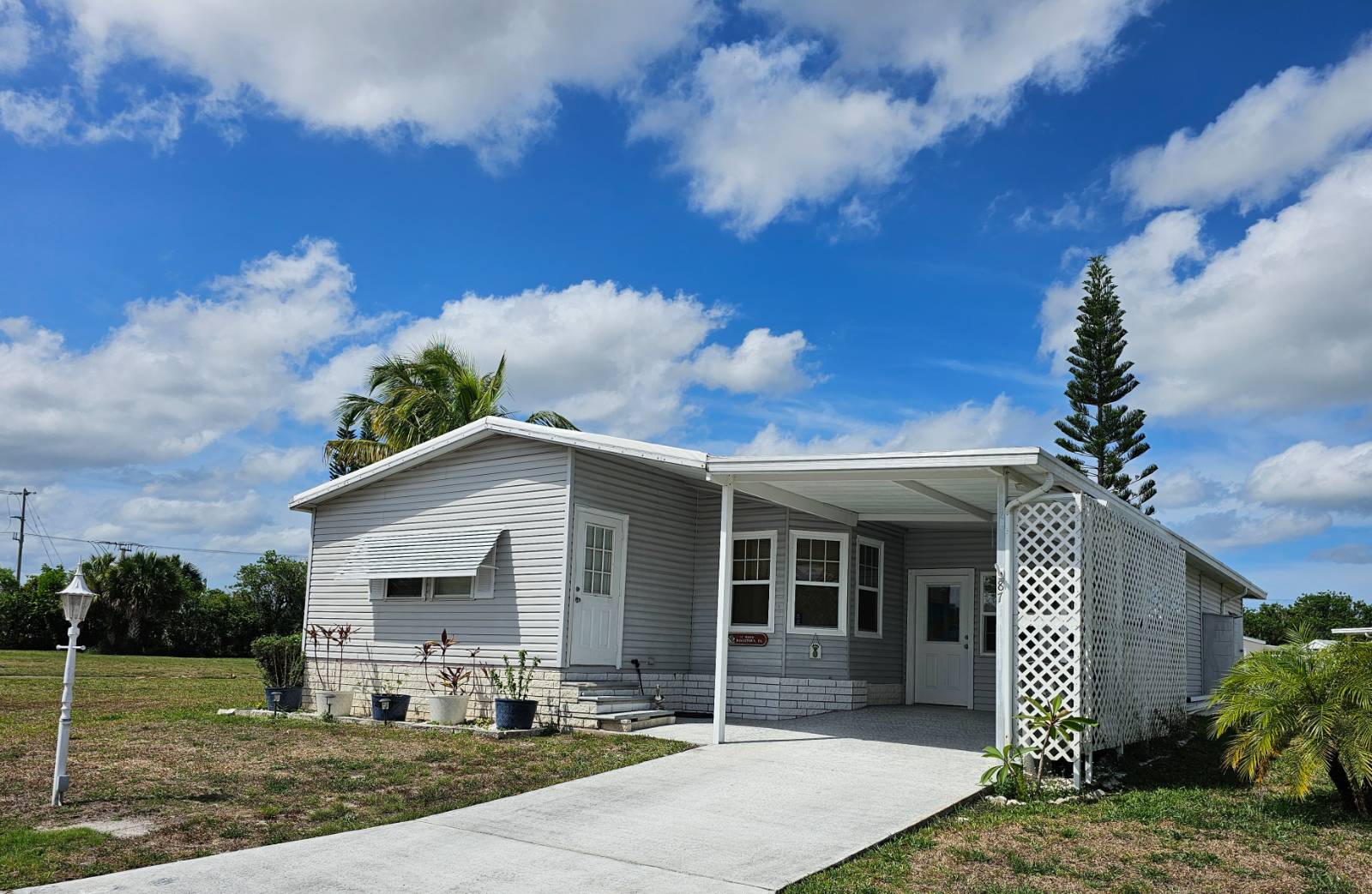 Welcome to Vero Palm Estates, 55+ Community. Your 1990 2B/2B home sits on a large corner lot and has many updates; Vinyl Plank Flooring throughout the home with 5&quot; baseboards. Tastefully painted and updated Kitchen Cabinets, Extra Large Master Bedroom with ensuite with walk-in shower. 2023 A/C, Rubber Roof and large shed with exterior golf-cart door.  Updated Vinyl Windows. Home has front entry to the perfect office or den.  Home includes all appliances, stackable front load washer/dryer and deep freeze in shed. Home has been meticulously cared for. Lot rent at $942.00 per month and includes gated entry, lawn maintenance, use of all the amenities; pool, sport courts, clubhouse, craft room, workout room, ect. Plus, all the activities to keep you busy all year round. Come enjoy the Lifestyle of a Resort Style Community just minutes from Vero Beach. Park Approval is Required. Contact the listing agent today for more information or to schedule your appointment today.