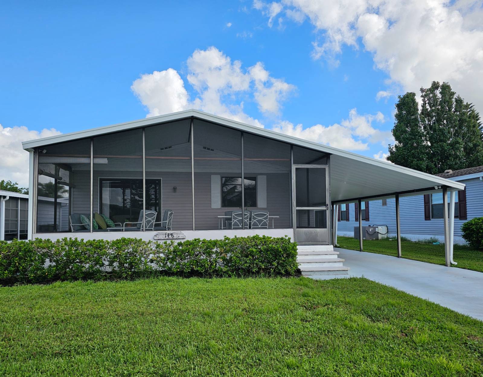 Welcome to your charming retreat in the heart of Heron Cay, a desirable 55+ community in Vero Beach! Home comes tastefully furnished - just bring your bags, move-in ready. Home has been updated with Roof, A/C Unit and Hot Water Heater 2019 and a Carport 2022. Flooring has Luxury Vinyl Planks and updated subfloor throughout the home. Includes all appliances and security camera with no monthly fee. An exterior GFI has been installed for golf cart charging. This makes the perfect 2nd home and spacious for full time beach living. The front patio/lanai is 23' x 10' and fully furnished for outdoor Florida living - with a view of lake. The kitchen comes fully stocked with all the essentials and has a new refrigerator/icemaker 2024. Master Bedroom has large walk-in closet, barn door entry to walk-in shower/vanity. Guest Bedroom has walk-in closet and comes with two beds for guest. Shed for storage. Heron Cay is the best of Resort Style Living just minutes from Vero Beach. Come enjoy all the amenities the community offers; heated pool, jacuzzi, sauna, workout room, crafts, billiards, library and all the sport courts; tennis, pickleball, bocce, shuffleboard and more. PET FRIENDLY.  4-Point Inspection April 2024. Park Approval will be required - call the listing agent today for more information.