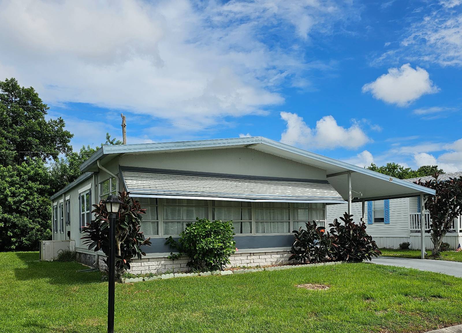 Home is move-in ready with private backyard. This 2-bedroom / 2-bathroom home has large Florida room and large workshop/shed for the hobbies and beach toys. Home has a durable rubber roof, recently sealed and A/C that's been maintained.  Sub-floor updated with vinyl planks. Home is in the desirable community of Village Green, just minutes from some of Florida's most beautiful beaches and downtown. Come live the beach vibe life and relax within minutes of a resort style life. The community offers an array of activities and amenities to keep you active in your retirement years. Amenities include but are not limited to year-round heated pools, workout room, craft room, billiards, sport courts, horseshoes and more. Contact the listing agent today for more information or to schedule your appointment.