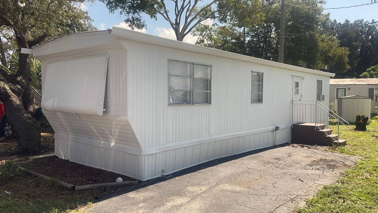 Great Opportunity to own an affordable Mobile Home in a desirable 55 plus community in Melbourne Florida. Shady Oaks Mobile Home Park is a safe and quiet community with longtime residents and an affordable lot rent of only 575 a month. 1920 Stewart Rd is centrally located, close to shopping, dining, local attractions, the Indian river and Beaches. This home is situated on a Shady lot, with a covered outdoor area and off-street parking. Recently renovated and with many updates both on the exterior and interior, makes this a perfect home for a single person, or couple, year- round resident or snowbird. The Floorplan Features an open Plan allowing ample space and Plenty of Natural sunlight. The Kitchen is complete with New Cabinets and new countertops. There is new vinyl flooring in the main area with new carpeting in the bedroom. The Bedroom offers a generous amount of space for a bedroom set along with double closets.