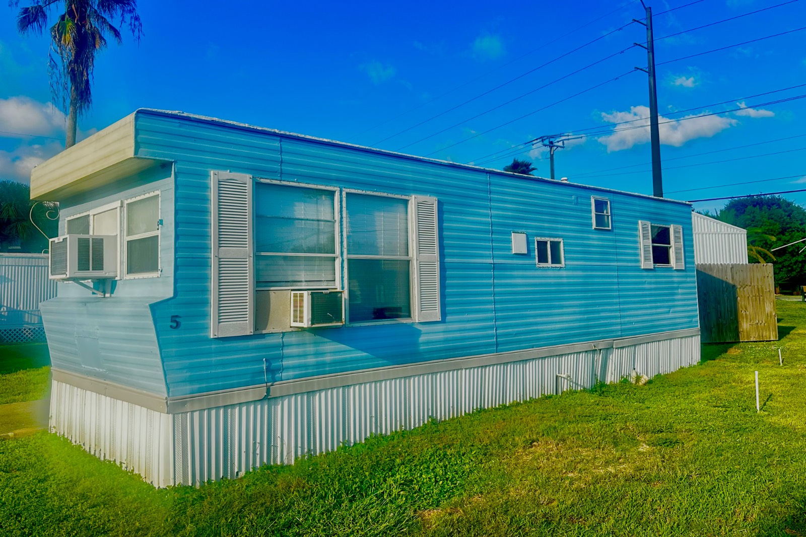 You'll find This beachside beauty is fully furnished, offering 1 bedroom and 1 bath with everything you would need to start living in paradise.  Located in Southgate Mobile Home Park, A quiet 55+ community, with a serene setting that welcomes pets and offers an affordable lot rent that is only $605 a month. You can ride your bike to Port Canaveral, enjoy sunrises and sunsets at Peacock Beach, and explore the world-famous Cocoa Beach Pier, all within minutes. This home is move-in ready and complete with all furnishings (as seen in the photos). Perfect for a single or couple, Snowbird or year-round resident.  There is plenty of natural sunlight throughout this home and built in storage in the bedroom. Upgrades Include: tankless water heater, new window treatments, updated electric with a new panel box, updated plumbing, hardwood flooring, a new window unit, and new interior paint. The roof has recently been resealed. The bathroom has been updated and is sparkling clean, featuring a stand-up shower and new fixtures.  For your outdoor enjoyment, there is a cement pad that is great for grilling and having guests over. Call Listing agent to set up a time to View this property,