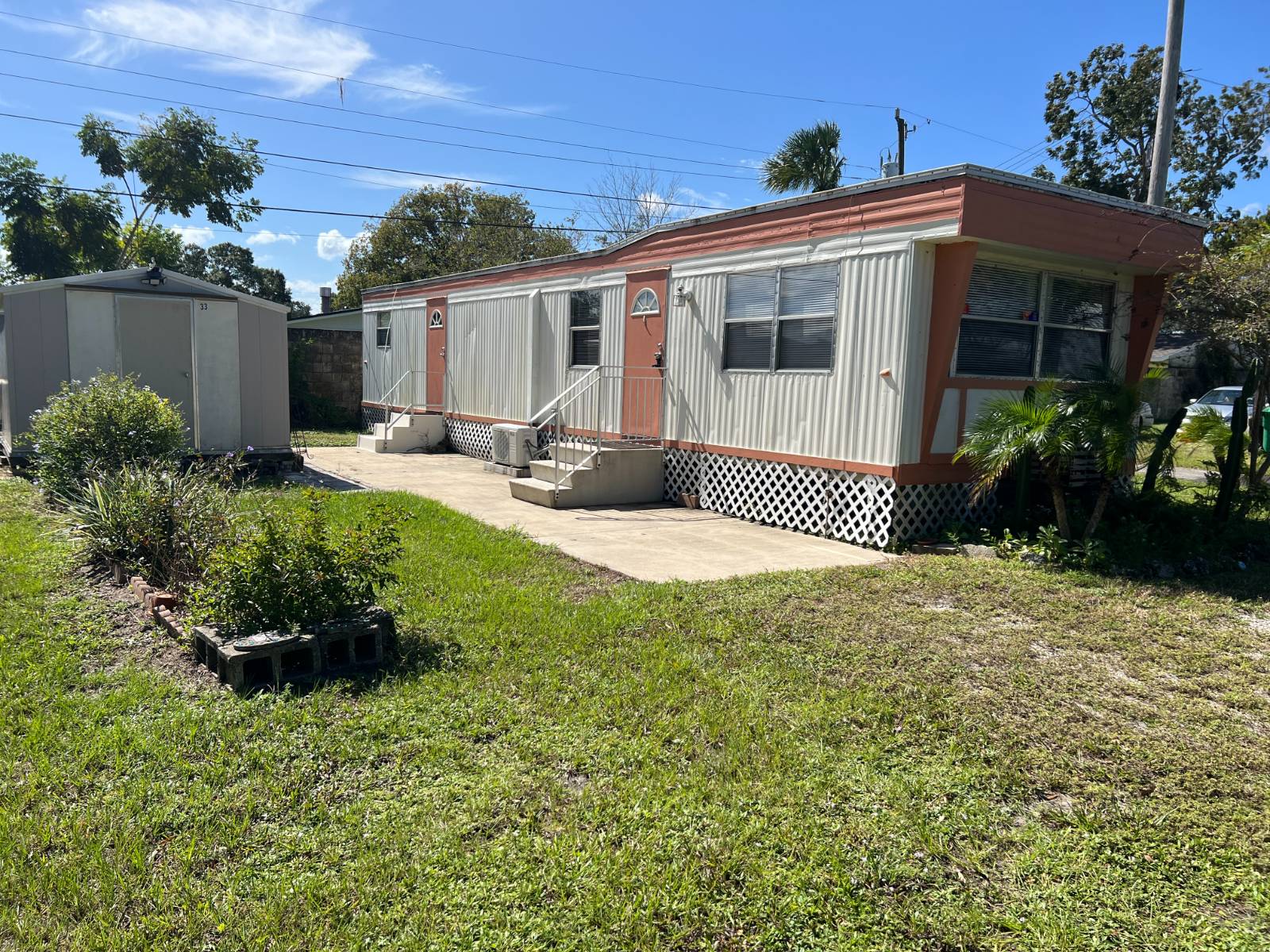 This affordable 55+ community on the Space Coast is located close to US-1 and I-95 and is conveniently located between Orlando, Daytona, and Melbourne.  There are plenty of attractions within 1/2 hour or just enjoy the quiet serene setting with a vacant lot next door. There is plenty of parking in the vacant lot for your convenience.  This well maintained and continually upgraded 2 bedroom, 1 bath, open concept home has a low lot rent of $750 per month and very low utility costs.  2 yr. old Roof. There is a quality shed included just steps away from the home and the shed houses the washer, dryer and water conditioner (included).  The newer mini-split AC keeps your new home at your ideal temperature for your comfort.  The flooring is newer laminate and has a beautiful wood floor look.  Park approval is required prior to purchase. This is a CASH ONLY listing. Call today for a showing!