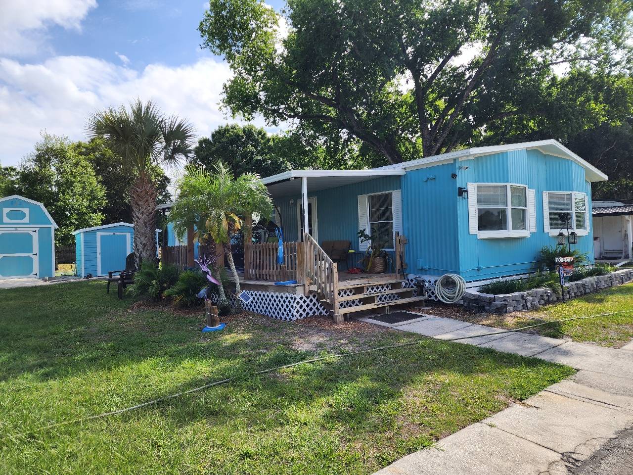JUST REPAINTED Snag This Steal at $375 LOT RENT!  Prime Melbourne, FL gem alert! Nestled in the heart of a 55+, pet-loving paradise, this beauty boasts LOW $375 lot rent and unbeatable vibes. Stroll to shopping, groceries, and dining-convenience is your new BFF. With 3 beds, 2 baths, inside laundry, and a sprawling open living area, it's your dream pad. Feast in the dining room, and enjoy the smart split floor plan, and tinker in two powered sheds (sorry, the big one's not staying).  The furniture can stay or bring your own. Yard? Check. Quick hop to Wickham Rd and I-95? Double check. This rare find won't last-call Scott NOW to tour!