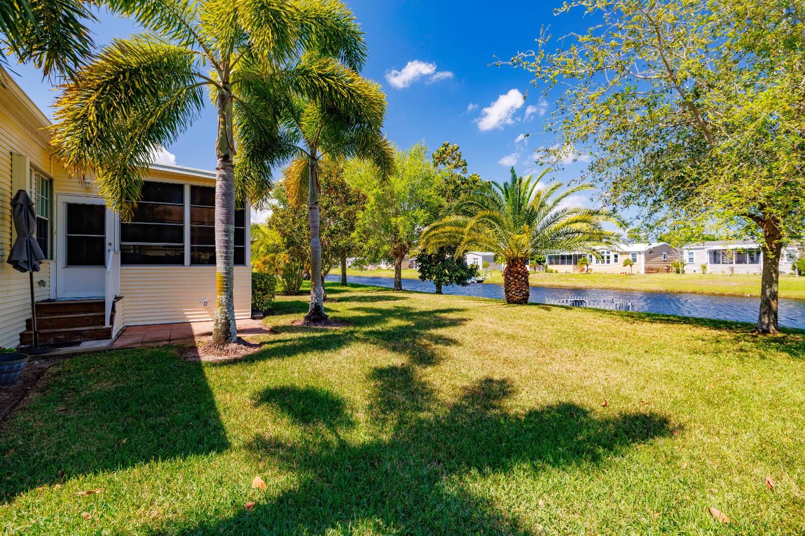 Step into a life of luxury and leisure at Park Place, Sebastian's premier 55+ retirement paradise! This stunning 2013 Palm Harbor doublewide manufactured home boasts 3 bedrooms, 2 full baths, soaring tall ceilings, and a sleek, updated kitchen-perfect for living your best years in style. But the real showstopper? Jaw-dropping lakefront views from your own floating dock, framed by a front porch with chic aluminum railing and a dreamy Florida room where you'll sip coffee as the sun dances on the water. Nestled between protected land and serene waves, this retreat offers privacy that's pure bliss-no nosy neighbors, just nature's embrace.   Welcome to resort living redefined! This gated, 55+ haven is your ticket to a vibrant, carefree lifestyle, with a low lot rent of just $1,020 per month. Dive into the action with a Heated Swimming Pool, Fitness Center, and Clubhouse buzzing with energy. Smash it on the Tennis or Pickleball Courts, shuffle into fun at Shuffleboard, or paddleboard across the lake under the sun. Unwind on the Sundeck, grill with friends at the BBQ Area, or get competitive at Bocce Ball. With Free Wi-Fi in common areas, a Library, and Card Tables, every day feels like a five-star getaway. (More photos coming soon)