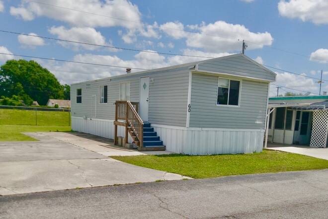 Welcome to This charming, updated manufactured home located at 83 Stebbins Dr., Lot Number 60 within Grove Shores  an exclusive 55+ community in Winter Haven, Florida. Offering an affordable Monthly lot rent of  710 a month , small pets are welcome and water is included!!     This delightful two-bedroom, one-bath residence has been thoughtfully renovated to blend modern comforts with relaxed Florida living. Step into a bright and airy interior featuring all-new vinyl flooring, updated appliances in a sleek kitchen, a freshly remodeled bathroom with contemporary fixtures, and the convenience of washer/dryer hookups. Central heat and air ensure year-round comfort, while a small front porch offers the perfect spot to savor your morning coffee, and a modest backyard provides a peaceful retreat.    Nestled in a lakefront community, Grove Shores offers serene views and a tranquil atmosphere. Residents can enjoy shuffleboard courts, the clubhouse and Lake Lucy, perfect for those who love spending time on the water. Whether you're looking to relax by the lake, engage in community activities, or simply enjoy the peaceful surroundings, Grove Shores provides an ideal setting.    Beyond the community, Winter Haven boasts a variety of attractions. Residents enjoy easy access to vibrant shopping centers, eclectic boutiques, and a variety of dining options that capture the essence of Florida's laid-back lifestyle. The area is home to **LEGOLAND Florida Resort**, the scenic **Chain of Lakes**, and numerous parks and cultural landmarks. Whether you're in the mood for a leisurely day cruising on the lakes or an afternoon of boutique shopping and dining, everything you desire is conveniently nearby.    Embrace the opportunity to downsize without sacrificing modern amenities or lifestyle. This beautifully renovated home presents both the tranquility of a quiet community and the excitement of nearby attractions, making it the perfect haven for active adults ready to enjoy all that Winter Haven has to offer.
